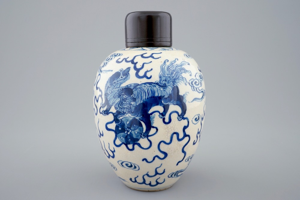 A Chinese blue and white soft paste jar with wooden cover, 19th C.